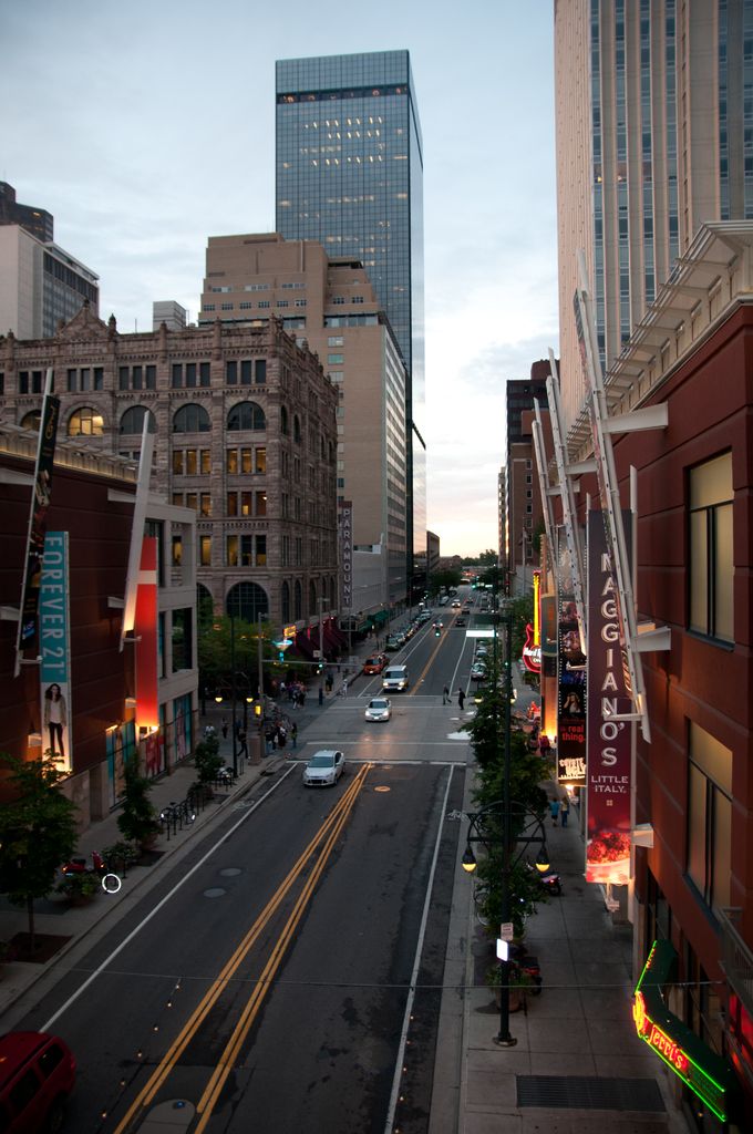 This image is clicked in the city. At the bottom, there is a road, on which there are cars. To the...